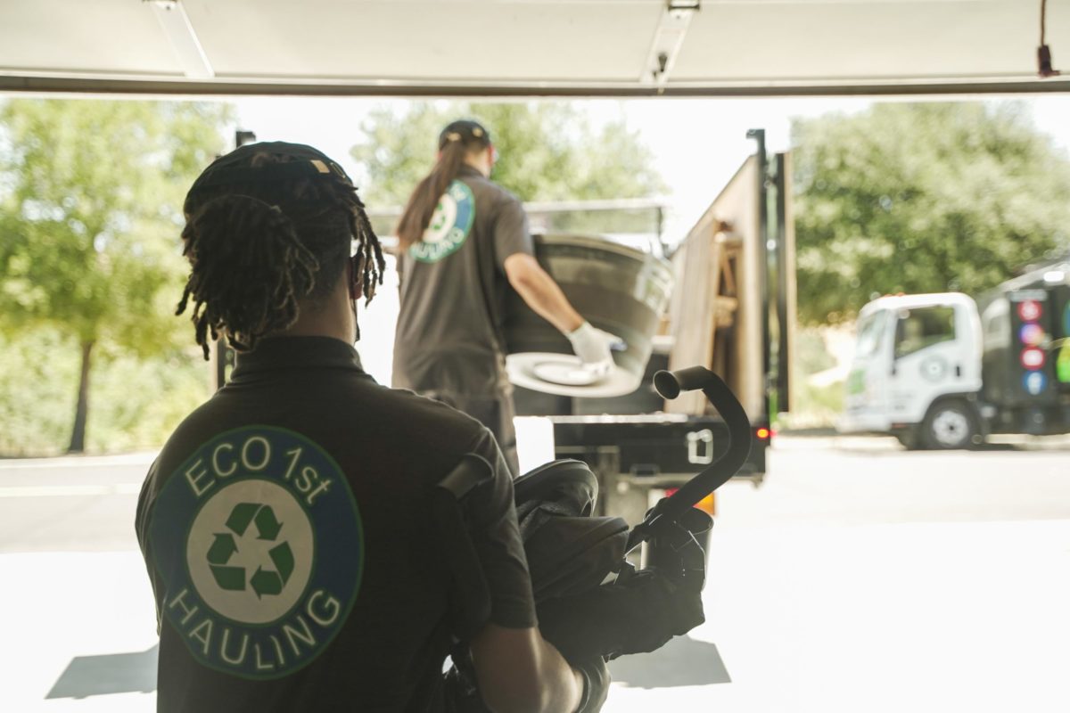 eco 1st junk removal team hauling junk from garage to truck